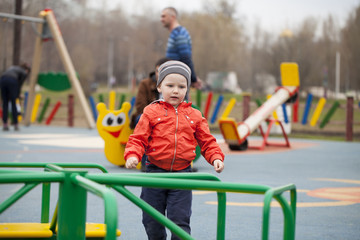 Fototapeta na wymiar The three-year young boy on the playground