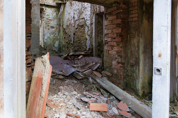 Dilapidated house, rubble and debris