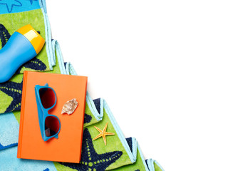 Towel, sunglasses and book