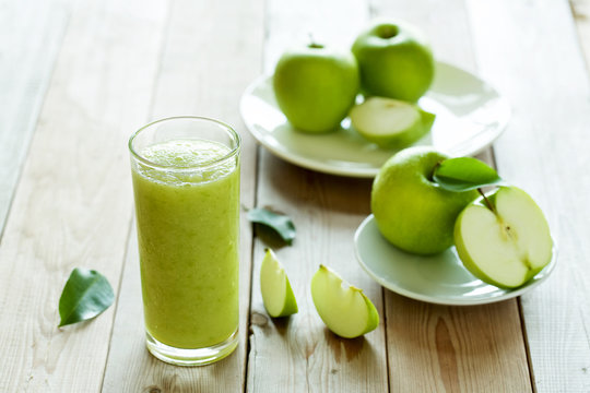 soft focus on grass of fresh apple juice on the wood background