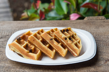Tasty waffles on wood table