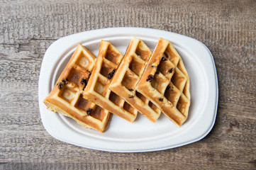 Tasty waffles on wood table