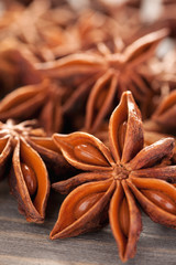 Star anise with seeds on a wooden table