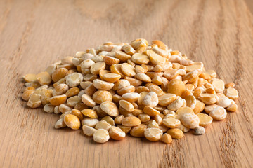 dried yellow peas on wooden background