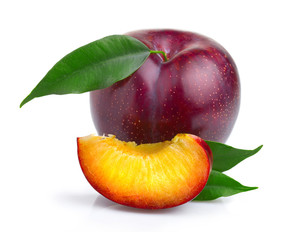 Ripe purple plum fruits with green leaves isolated