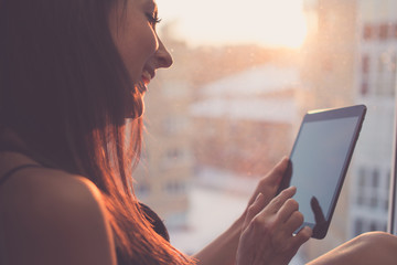 close up portrait of woman using table, sitting next to window, smiling