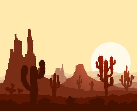 Sunset in stone desert  with cactuses and mountains.