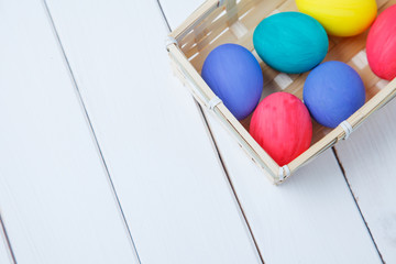 close up of colored easter eggs on wooden surface