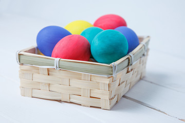 Easter eggs on wooden in vintage basket