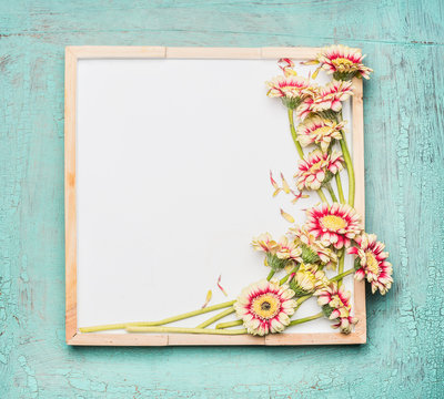 Blank  white chalkboard and pretty flowers bunch on turquoise shabby chic background, top view