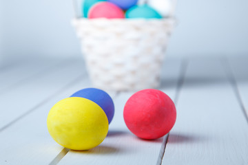 close up of colored easter eggs on wooden surface