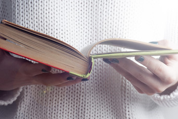 Young girle reading an  open book . old book. Books and reading are essential for self improvement,...