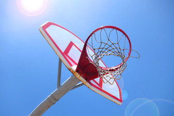 outdoors basketball hoop with bright sun flare