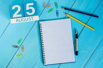 August 25th. Image of august 25 wooden color calendar on blue background. Summer day. Empty space for text