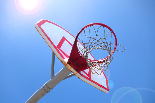 outdoors basketball hoop with bright sun flare