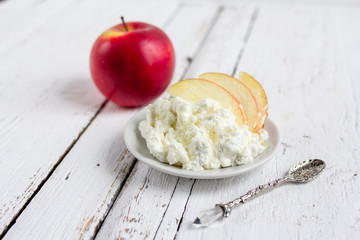 Cottage cheese, honey and Apple on a plate
