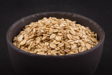 oat flakes on a dark stone board