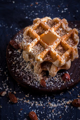 Belgian sugar waffles with grated nuts and caramel syrup