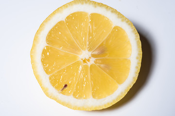 fresh, juicy slice of lemon on white background