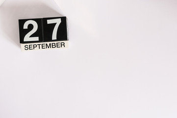 September 27th. Image of september 27 wooden table calendar on white background. Autumn day. Empty space for text