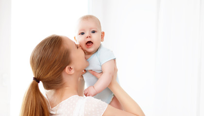 happy family mother playing  with baby