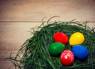 Green grass and colored Easter eggs