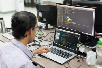 Asian Outsource Software Developer Looking Screen Sitting At Desk