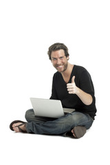 man with laptop gesturing approved