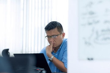 Asian Businessman Sitting Desk Working Laptop Pondering