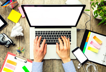 hands of a man using laptop with empty display