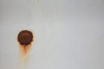 brown rusty spots on the old metal wall