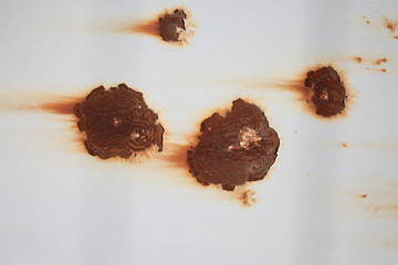 brown rusty spots on the old metal wall