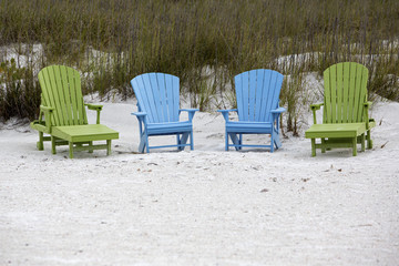 Adirondack Chairs sitting the beach.