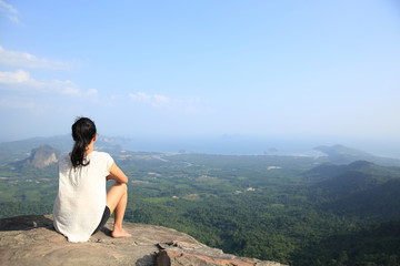 Naklejka na ściany i meble young asian woman enjoy the view at mountain peak cliff