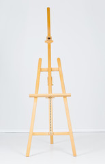 Wooden easel in white room