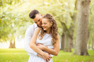 Fototapeta premium Young couple walking, Hyde Park, London: sunset colour tone