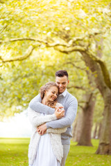 Fototapeta premium Young couple walking, Hyde Park, London: sunset colour tone