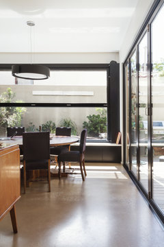 Modern Dining Room With Concrete Floor And Glass Bi Fold Doors