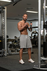 Fototapeta na wymiar Young Healthy Man Doing Exercise For Biceps