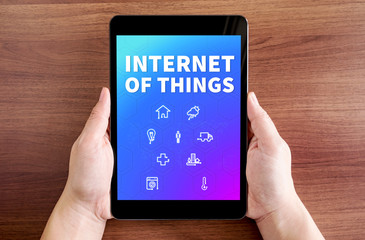 Two hand holding tablet with Internet of things(IoT) and icon on