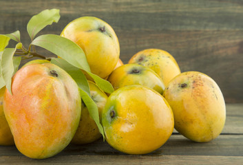 Mango tropical fruit on a wooden background