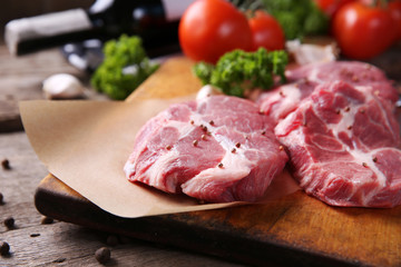 Marbled beef steak and spices on wooden background