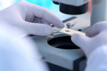 Serious clinician studying chemical element in laboratory