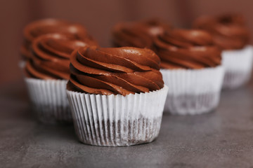 Chocolate cupcakes on grey background, close up