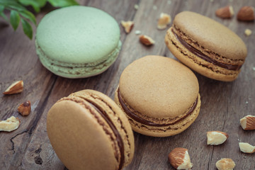 French macaroons and almonds on table, Filtered image
