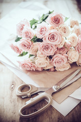 bouquet of fresh roses and scissors