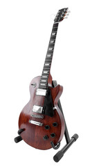 Brown electric guitar on a stand, isolated on white