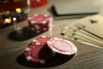 Set to playing poker with cards and chips on wooden table closeup
