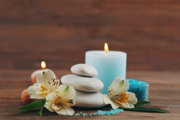 Fototapeta na wymiar Spa still life with light blue candle on wooden background