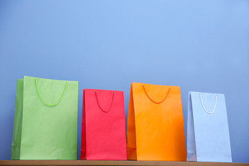 Colored paper bags on blue background